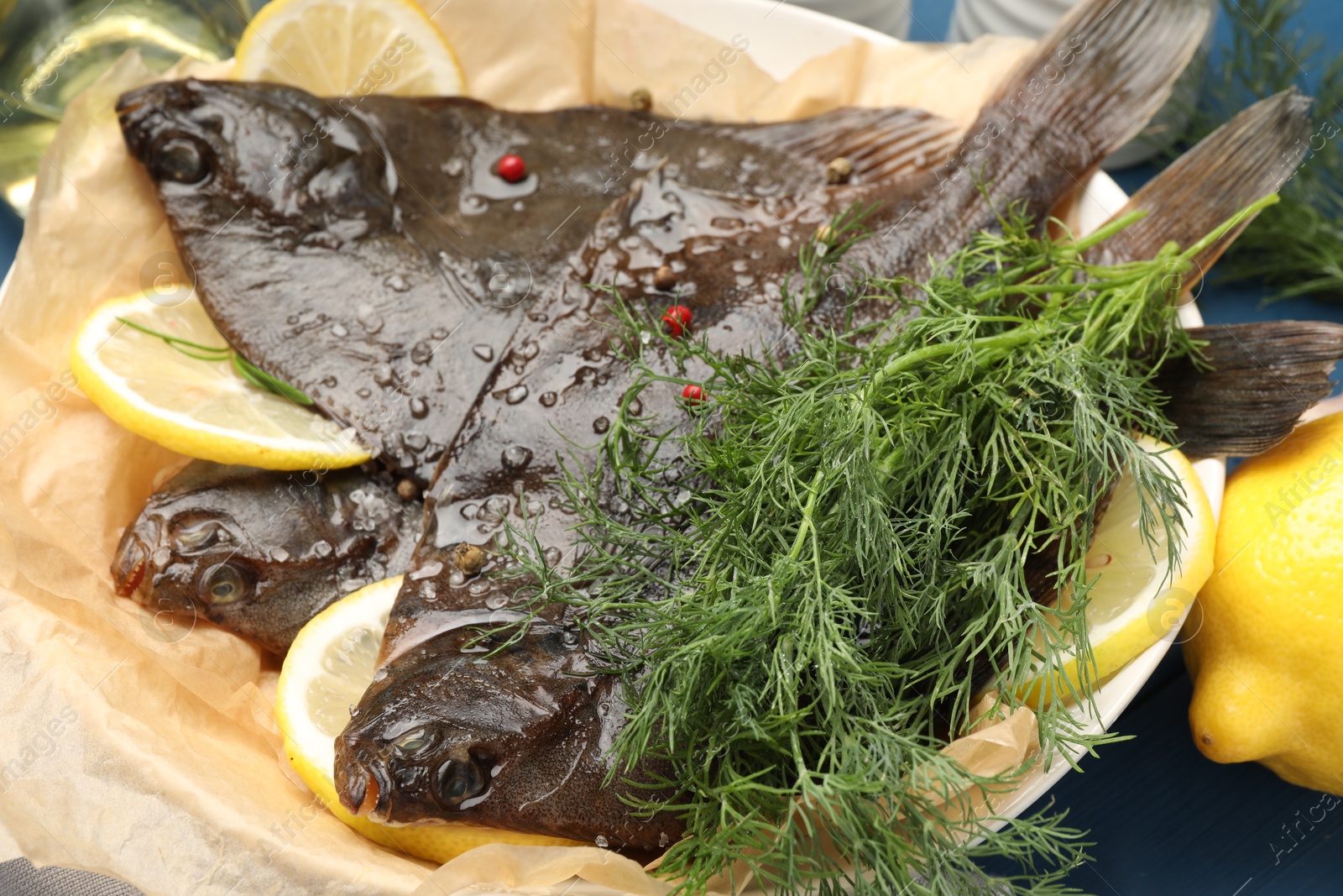 Photo of Fresh raw flounder fish and spices on table, closeup. Seafood