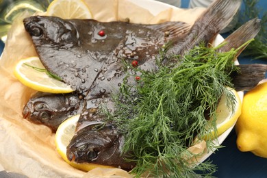 Photo of Fresh raw flounder fish and spices on table, closeup. Seafood