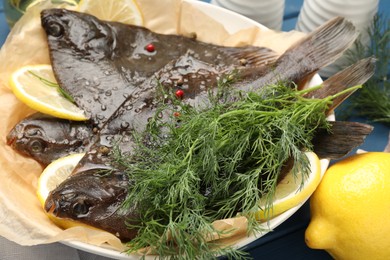 Photo of Fresh raw flounder fish and spices on table, closeup. Seafood