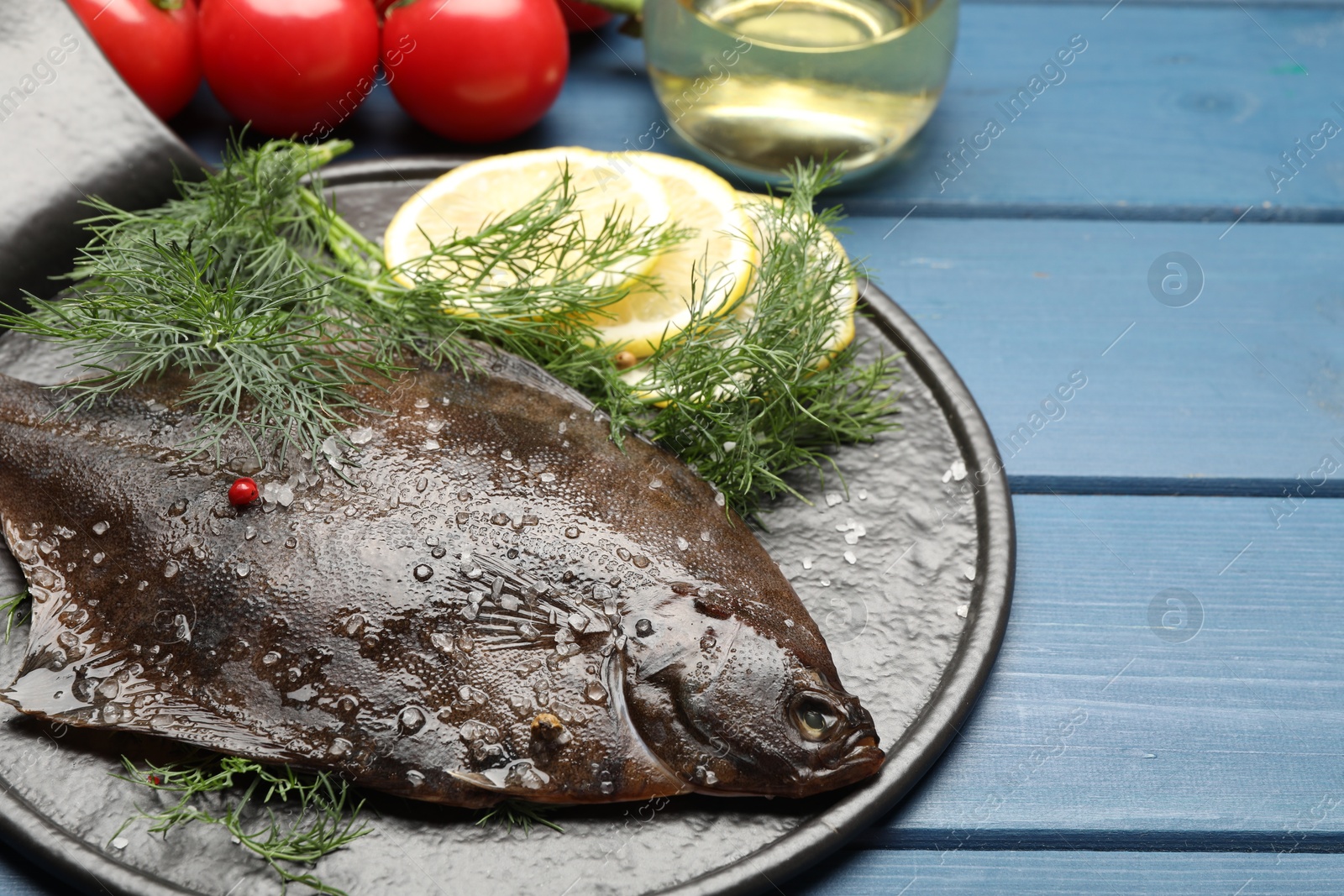Seafood. Fresh raw flounder fish and ingredients on blue wooden table, closeup. Space for text Photo of Seafood. Fresh raw flounder fish and ingredients on blue wooden table, closeup. Space for text