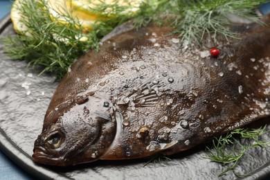 Photo of Fresh raw flounder fish and spices on table, closeup. Seafood