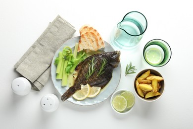 Photo of Tasty roasted flounder fish with celery served on white table, flat lay. Homemade seafood dish