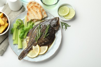Photo of Homemade seafood dish. Tasty roasted flounder fish with celery served on white table, flat lay. Space for text