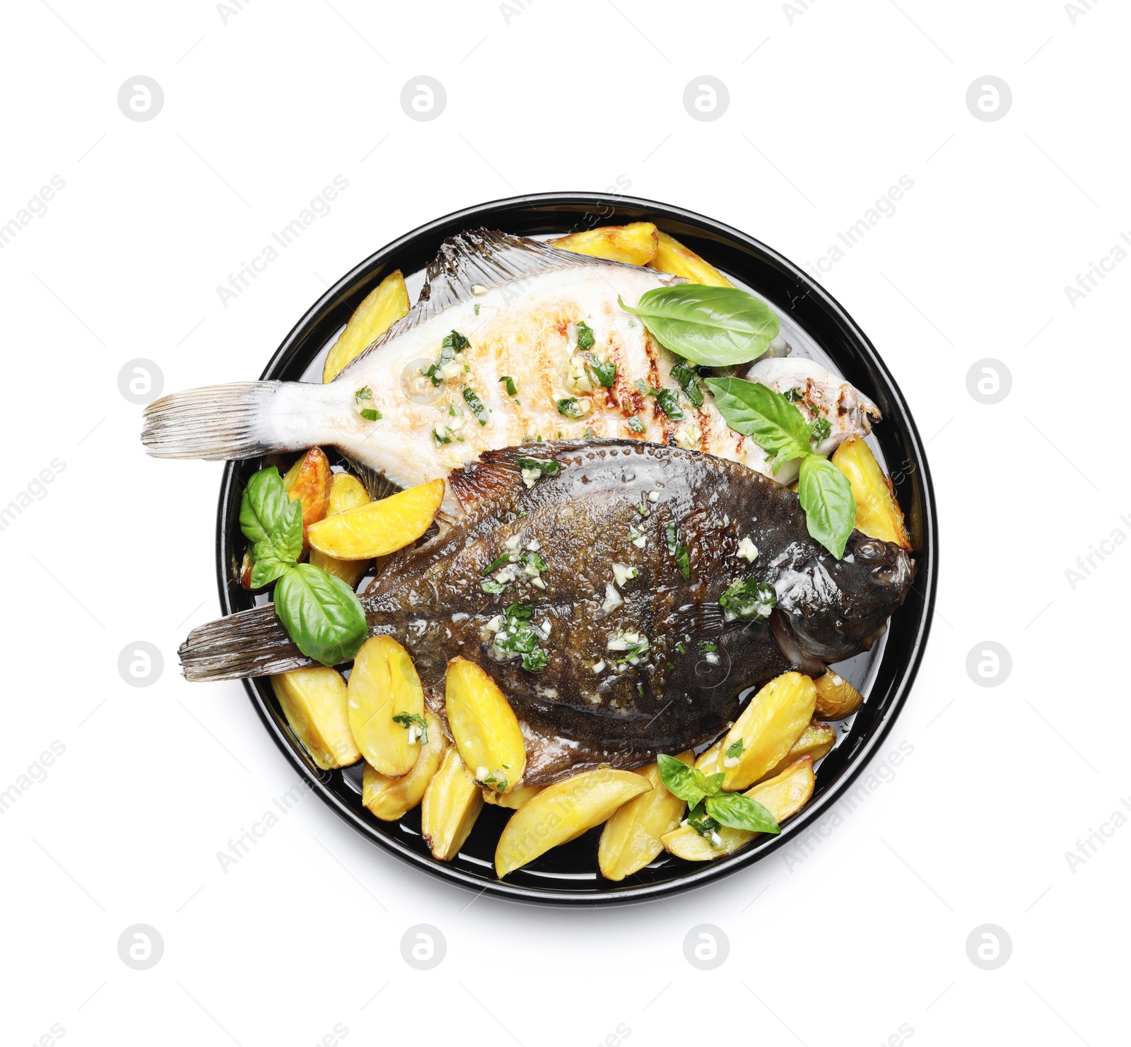 Photo of Tasty roasted flounder fish with herbs and potato isolated on white, top view. Homemade seafood dish