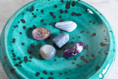 Photo of Aura. Different natural mineral stones on table, closeup