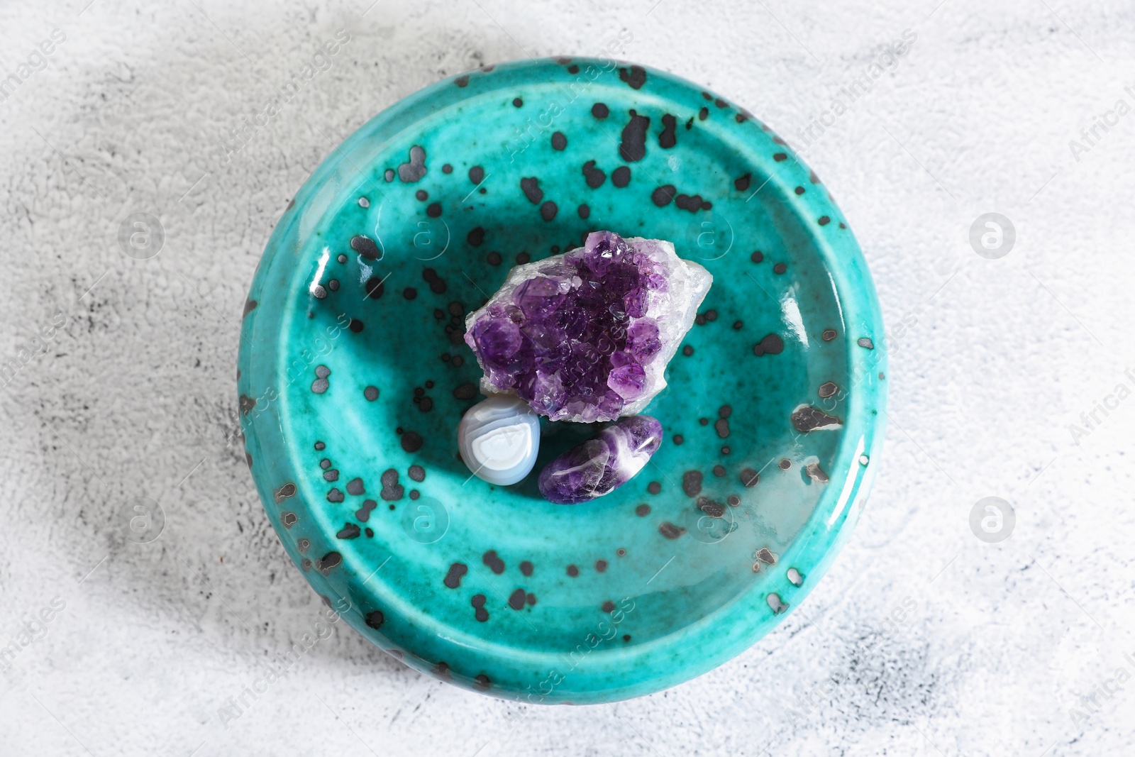 Photo of Aura. Different natural mineral stones on white textured table, top view