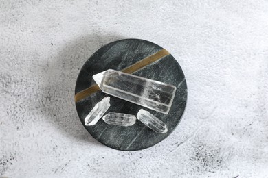 Photo of Aura. Beautiful crystals on white textured table, top view