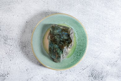 Photo of Aura. Beautiful labradorite on white textured table, top view