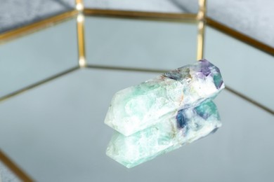 Photo of Aura. Beautiful fluorite on glass tray, closeup. Space for text
