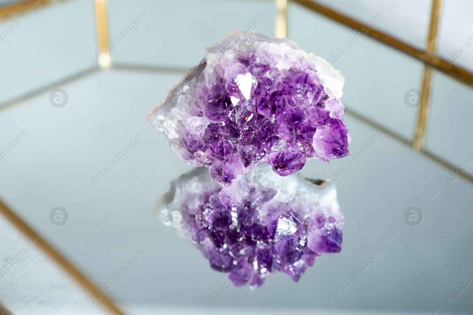 Photo of Aura. Beautiful amethyst on glass tray, closeup