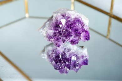 Photo of Aura. Beautiful amethyst on glass tray, closeup
