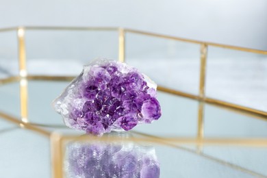 Photo of Aura. Beautiful amethyst on glass tray, closeup. Space for text