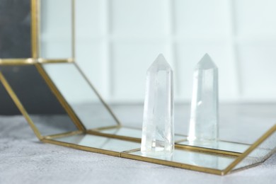 Photo of Aura. Beautiful crystal on white textured table, closeup. Space for text