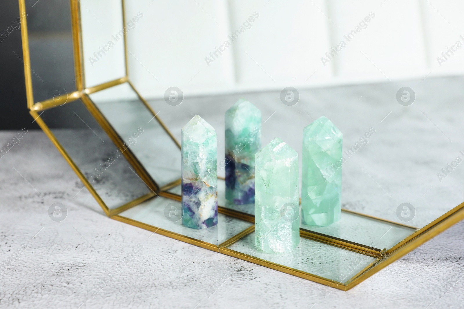 Photo of Aura. Beautiful fluorites on white textured table, closeup