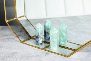 Photo of Aura. Beautiful fluorites on white textured table, closeup