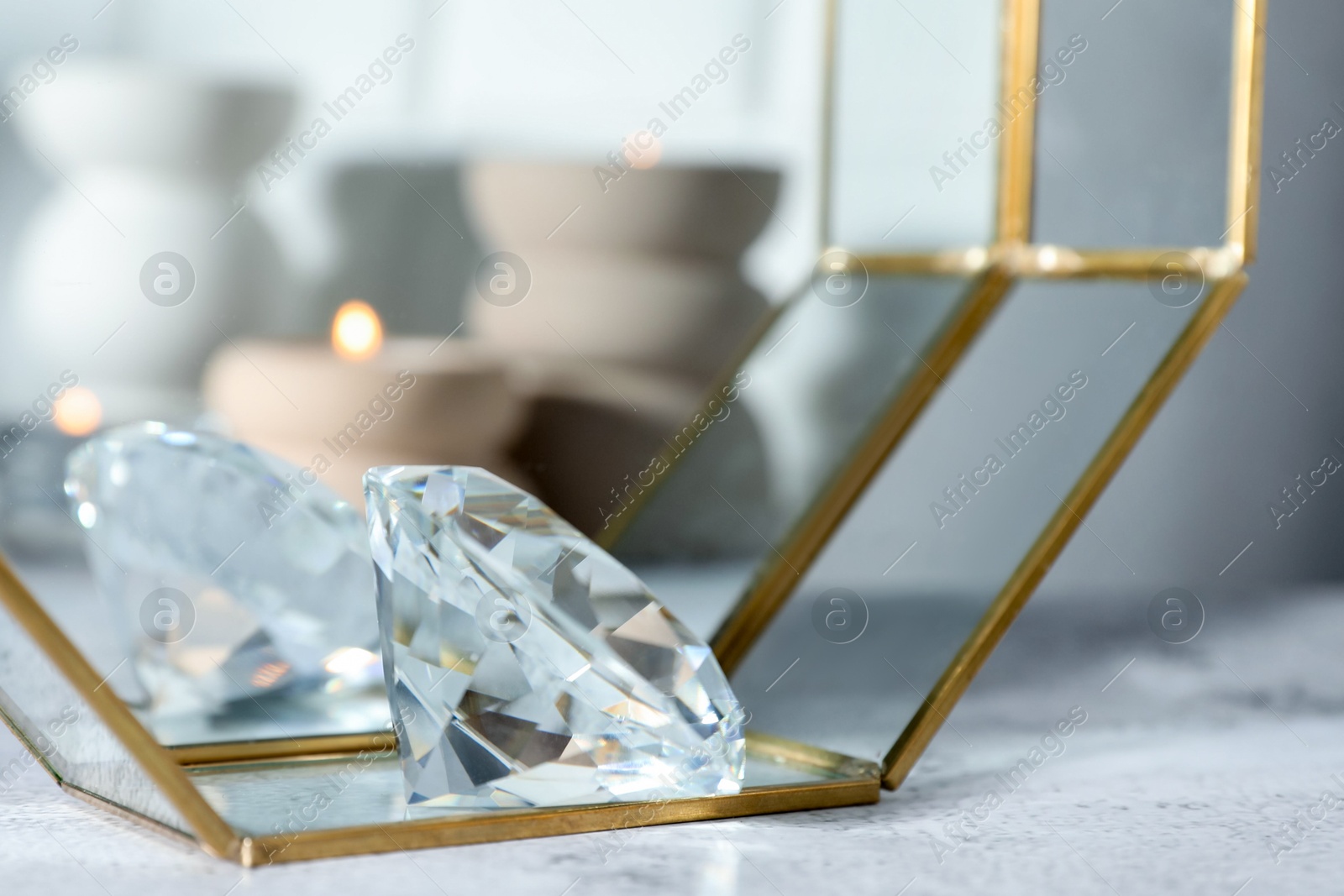Photo of Aura. Beautiful diamond on white textured table, closeup