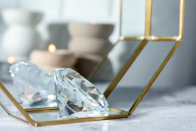 Photo of Aura. Beautiful diamond on white textured table, closeup