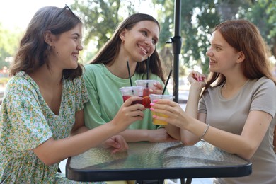 Photo of Friends enjoying refreshing drinks in outdoor cafe