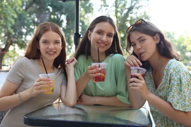 Photo of Friends enjoying refreshing drinks in outdoor cafe