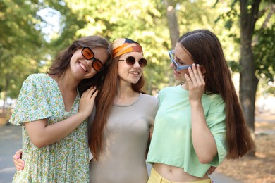 Photo of Portrait of happy friends with sunglasses outdoors