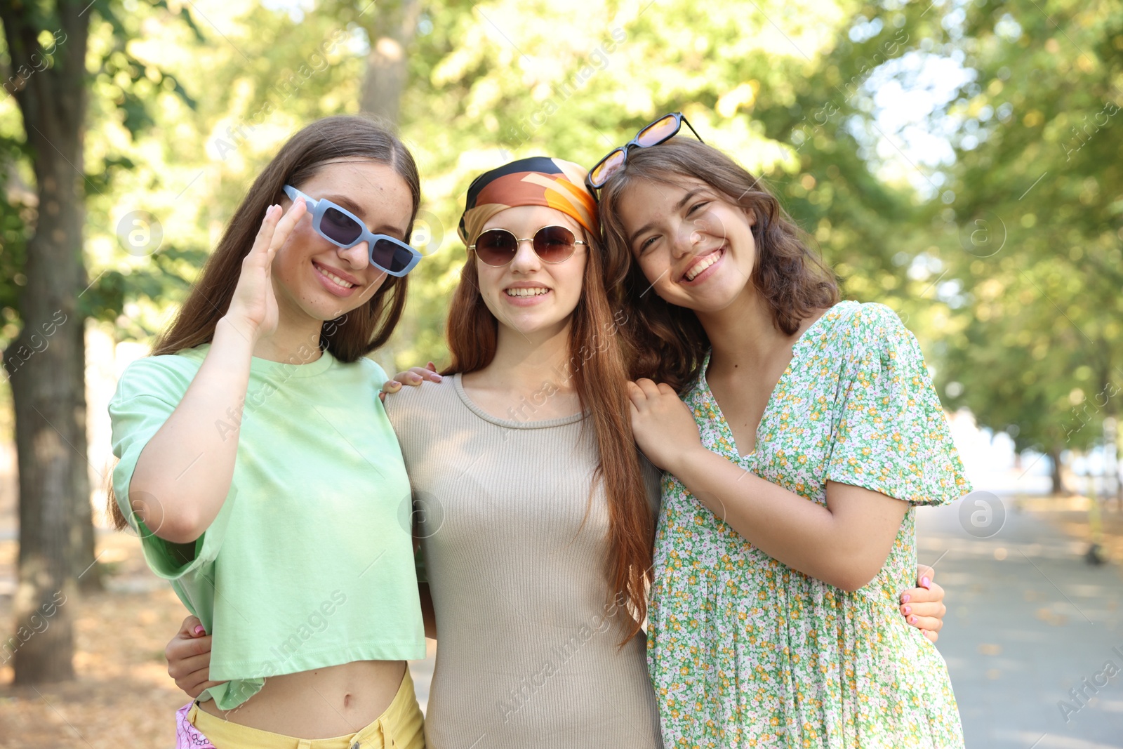 Portrait of happy friends with sunglasses outdoors Photo of Portrait of happy friends with sunglasses outdoors
