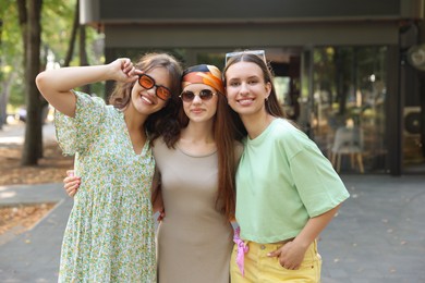 Photo of Portrait of happy friends with sunglasses outdoors