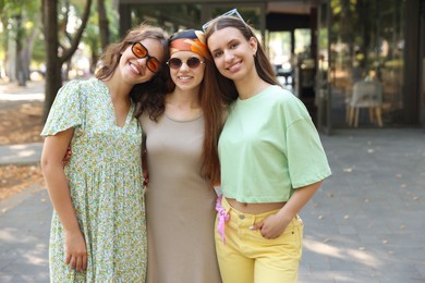 Photo of Portrait of happy friends with sunglasses outdoors
