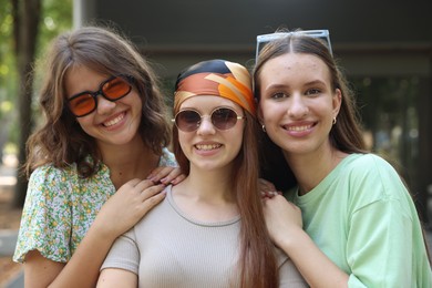 Photo of Portrait of happy friends with sunglasses outdoors
