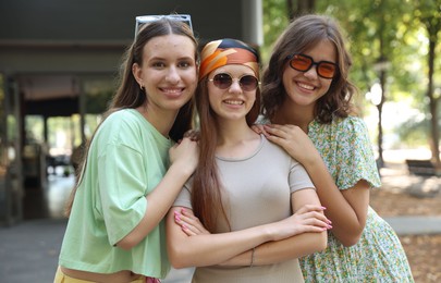Photo of Portrait of happy friends with sunglasses outdoors