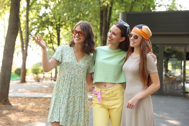 Photo of Portrait of happy friends with sunglasses outdoors