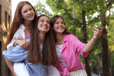 Photo of Happy friends having fun together on city street