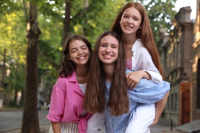 Photo of Happy friends having fun together on city street
