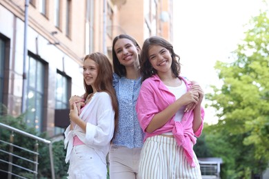 Photo of Portrait of happy friends on city street, low angle view