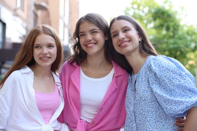 Photo of Portrait of happy friends on city street