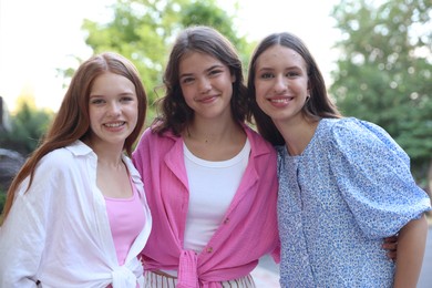 Photo of Portrait of happy friends on city street