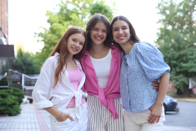 Photo of Portrait of happy friends on city street