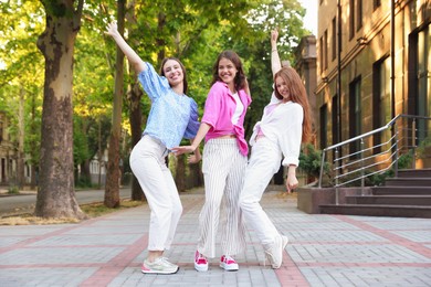 Photo of Portrait of happy friends on city street