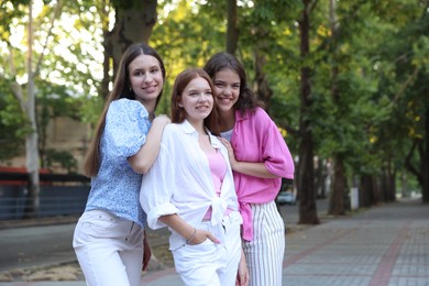 Photo of Happy friends walking together on city street