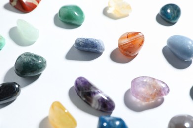 Photo of Aura. Different natural mineral stones on white background, closeup