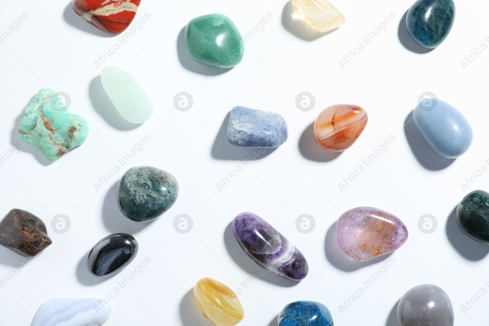 Aura. Different natural mineral stones on white background, flat lay Photo of Aura. Different natural mineral stones on white background, flat lay