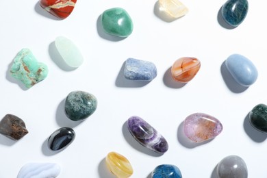 Photo of Aura. Different natural mineral stones on white background, flat lay