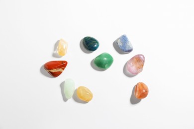 Photo of Aura. Different natural mineral stones on white background, flat lay