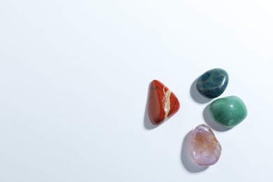 Photo of Aura. Different natural mineral stones on white background, flat lay. Space for text