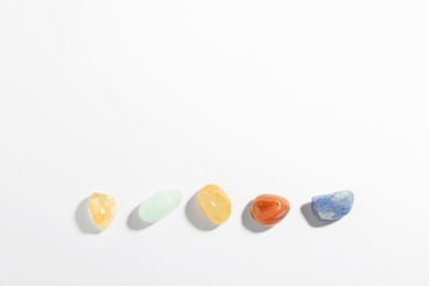 Photo of Aura. Different natural mineral stones on white background, flat lay. Space for text