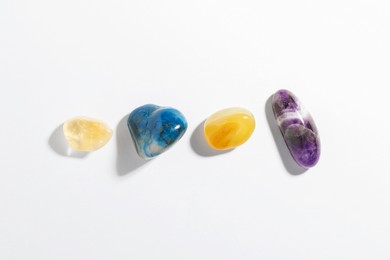 Photo of Aura. Different natural mineral stones on white background, flat lay