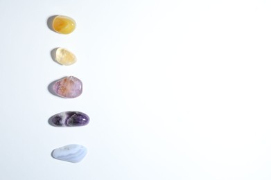 Photo of Aura. Different natural mineral stones on white background, flat lay. Space for text