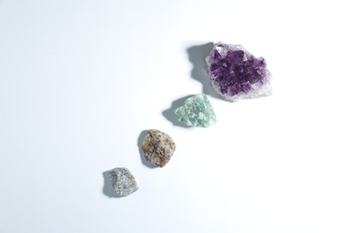 Photo of Aura. Different natural mineral stones on white background, flat lay
