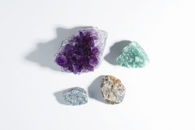 Photo of Aura. Different natural mineral stones on white background, flat lay