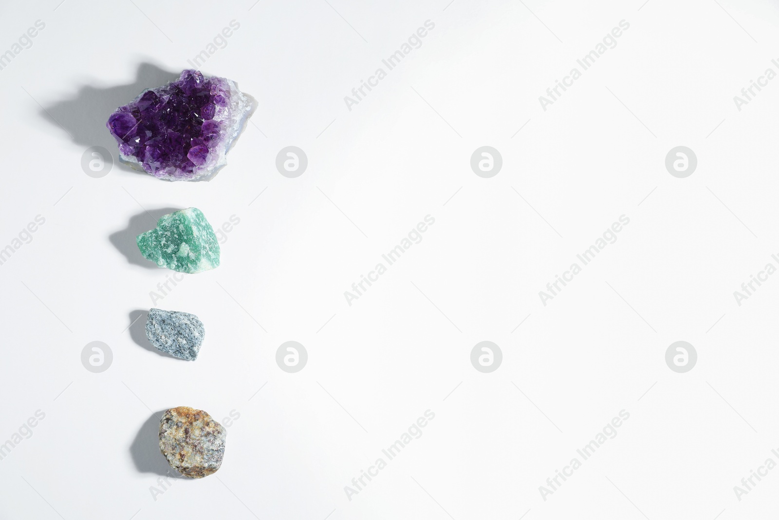 Photo of Aura. Different natural mineral stones on white background, flat lay. Space for text
