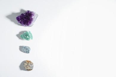 Photo of Aura. Different natural mineral stones on white background, flat lay. Space for text